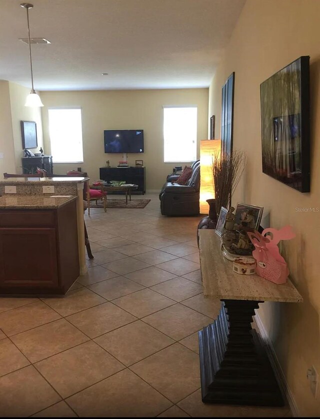 living room featuring light tile patterned floors and a wealth of natural light