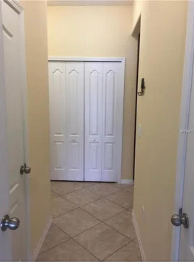 corridor with light tile patterned floors