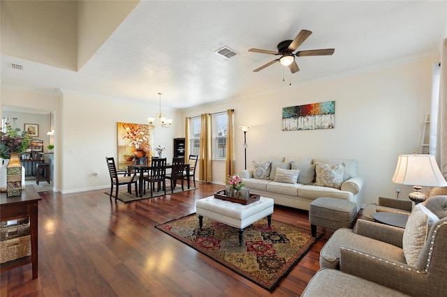 living room featuring ceiling fan with notable chandelier, dark hardwood / wood-style flooring, and crown molding