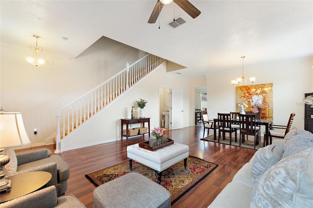 living room featuring ceiling fan with notable chandelier, dark hardwood / wood-style floors, and ornamental molding