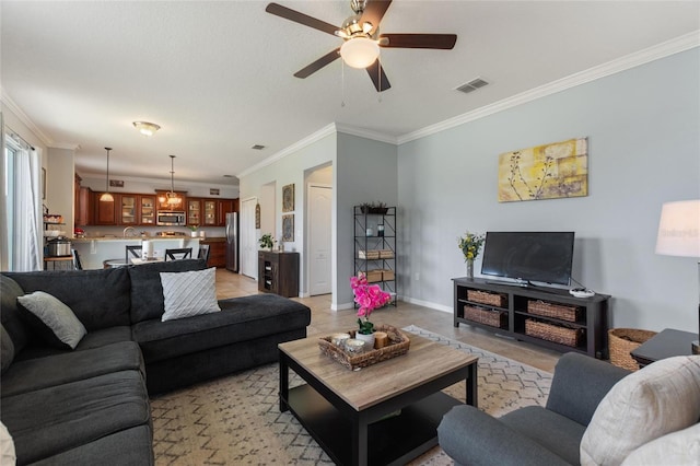 living room with ceiling fan and crown molding