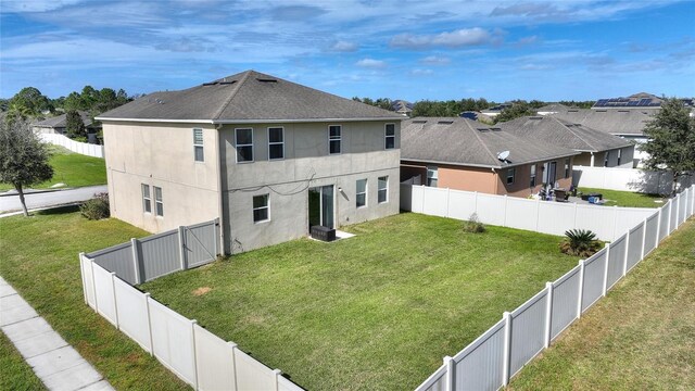 rear view of house featuring a yard