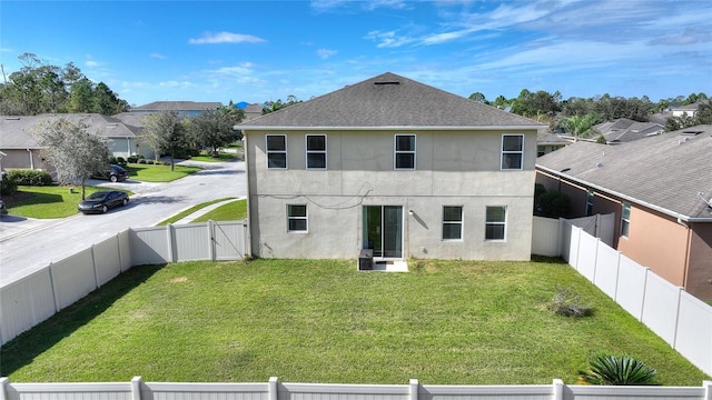 rear view of property with a yard