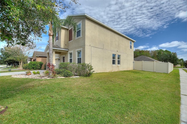 view of property exterior with a lawn and a garage