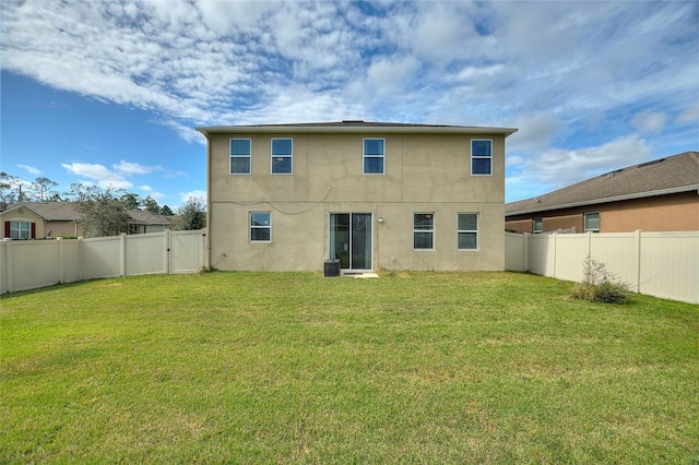 back of property featuring a lawn and central air condition unit