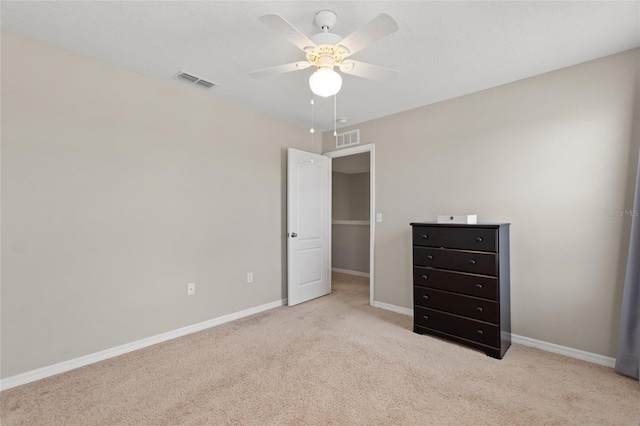 unfurnished bedroom featuring ceiling fan and light carpet