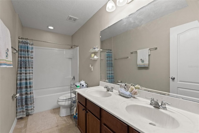 full bathroom featuring shower / bath combo, a textured ceiling, vanity, tile patterned flooring, and toilet