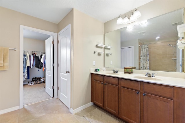 bathroom featuring vanity, tile patterned floors, and curtained shower