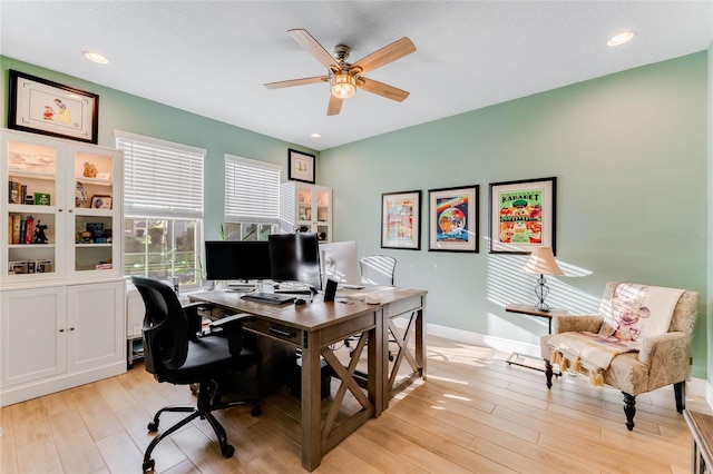 home office featuring light wood-type flooring and ceiling fan