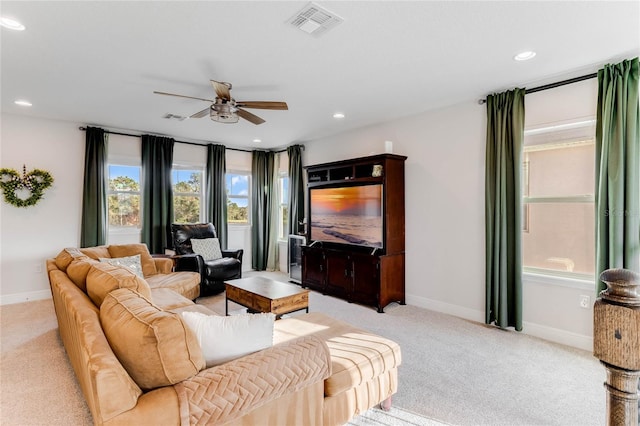 carpeted living room featuring ceiling fan