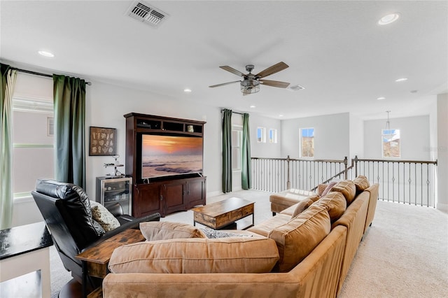 carpeted living room featuring ceiling fan