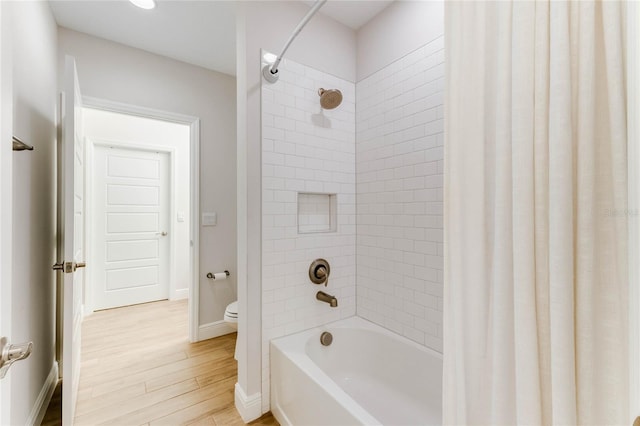 bathroom featuring shower / bath combo, toilet, and wood-type flooring