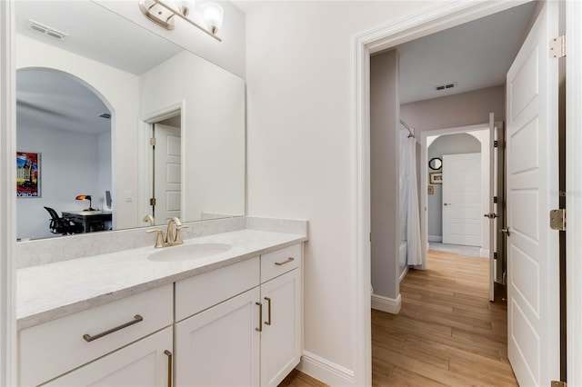 bathroom with vanity and wood-type flooring