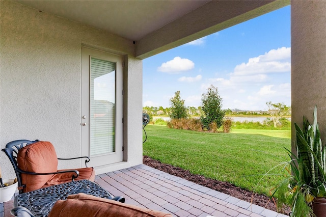 view of patio with a water view