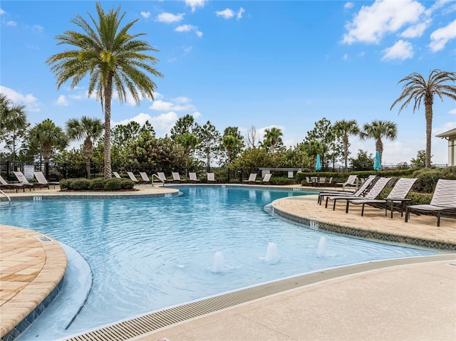 view of swimming pool with a patio and pool water feature