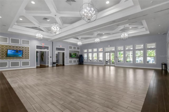 unfurnished living room featuring hardwood / wood-style floors and coffered ceiling