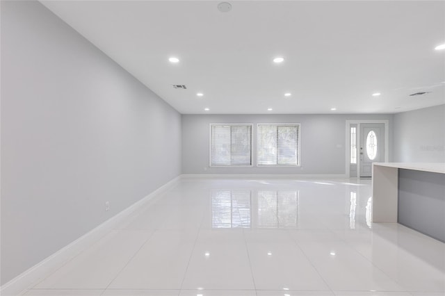 unfurnished living room featuring light tile patterned floors