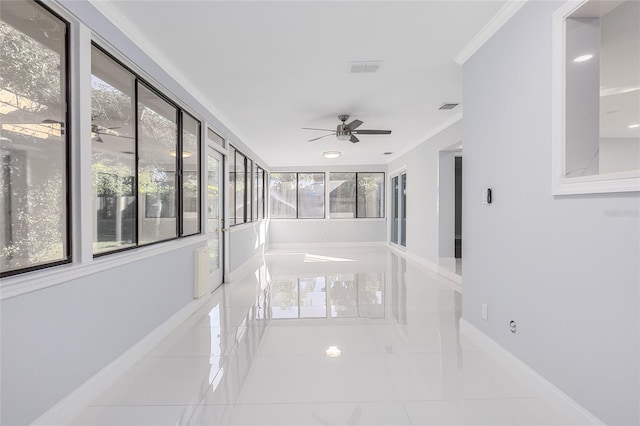 interior space featuring light tile patterned flooring and ornamental molding