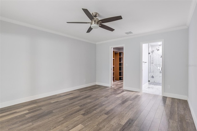 spare room with hardwood / wood-style floors, ceiling fan, and crown molding