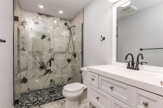 bathroom with vanity, toilet, and a shower with shower door