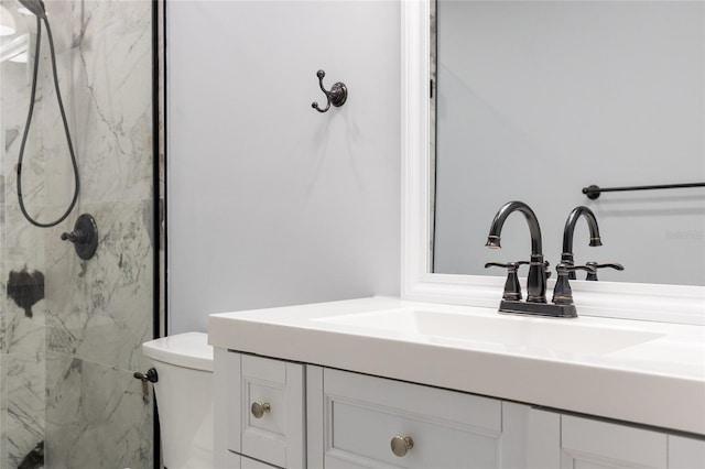 bathroom with vanity, toilet, and a shower with shower door