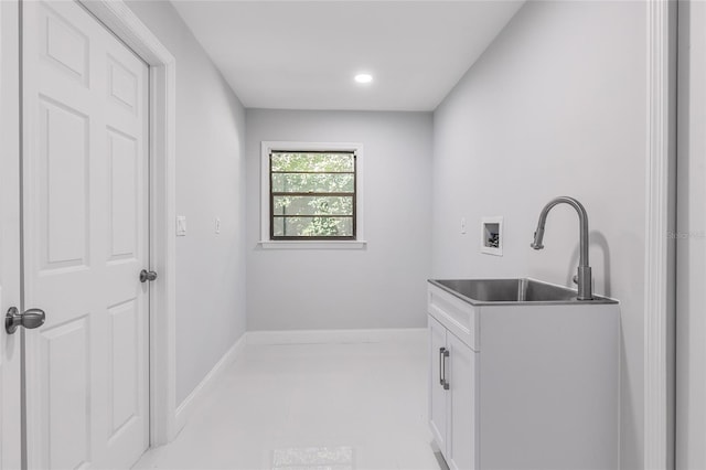 laundry area featuring cabinets, hookup for a washing machine, and sink