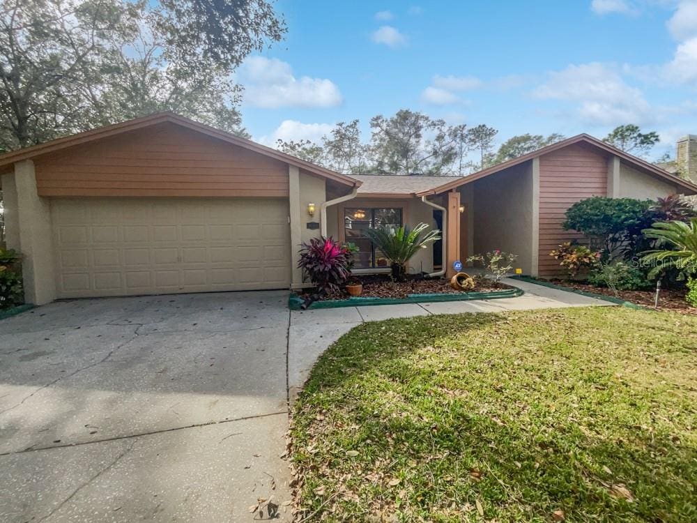 ranch-style house with a front lawn and a garage