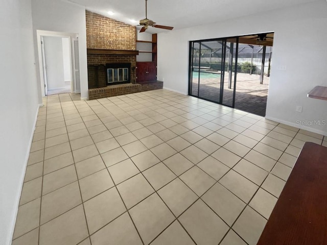 unfurnished living room with ceiling fan, light tile patterned flooring, and a fireplace