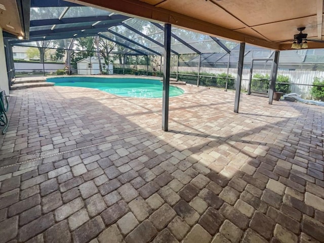 view of pool featuring glass enclosure and a patio