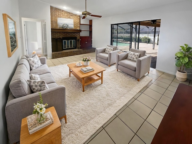 tiled living room featuring vaulted ceiling, a brick fireplace, and ceiling fan