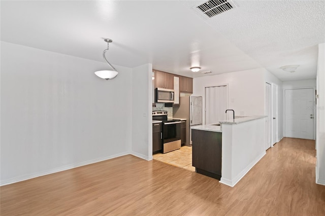 kitchen with light hardwood / wood-style floors, sink, and appliances with stainless steel finishes