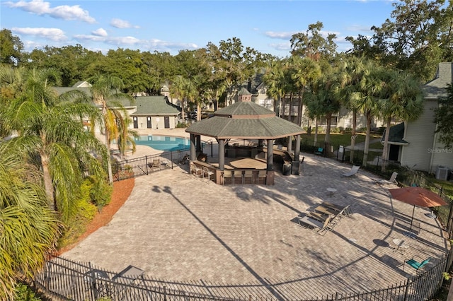 view of community featuring a gazebo, a swimming pool, and a patio