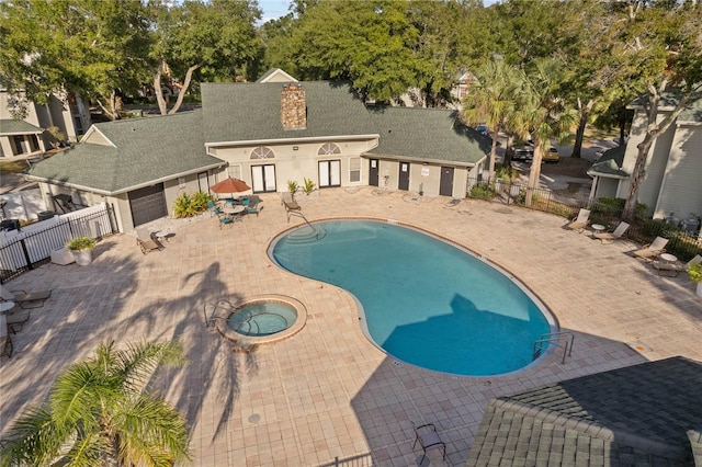 view of pool featuring a community hot tub and a patio