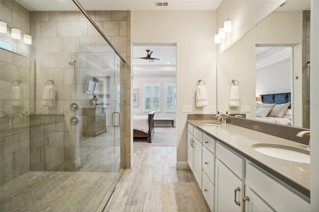 bathroom featuring hardwood / wood-style flooring, vanity, ceiling fan, and a shower with door