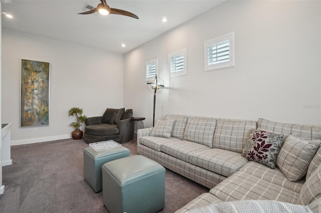 carpeted living room with ceiling fan