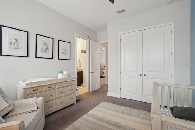 bedroom with dark colored carpet, connected bathroom, and a closet