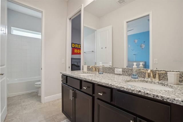 bathroom featuring toilet, vanity, and tile patterned floors