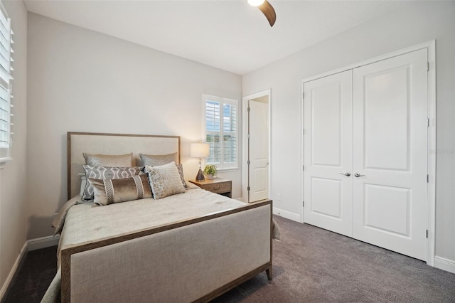 carpeted bedroom featuring ceiling fan and a closet