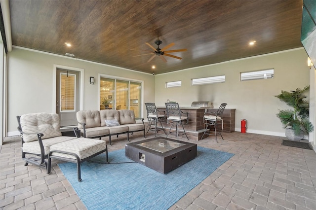 interior space featuring ceiling fan and an outdoor living space with a fire pit