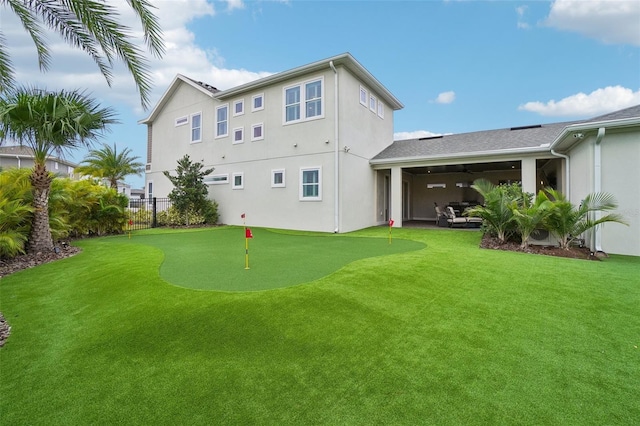 rear view of house featuring a lawn