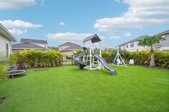 view of play area featuring a lawn and a trampoline