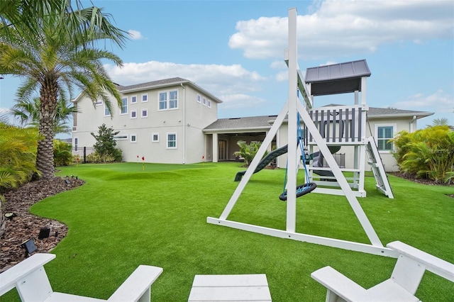 view of jungle gym featuring a lawn