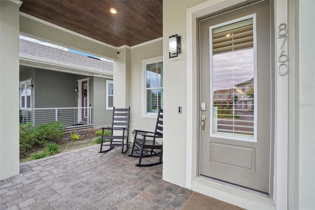 view of exterior entry featuring a porch