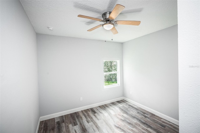 empty room featuring hardwood / wood-style flooring, ceiling fan, and a textured ceiling