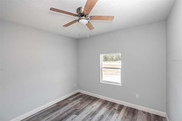 unfurnished room with a textured ceiling, ceiling fan, and dark wood-type flooring