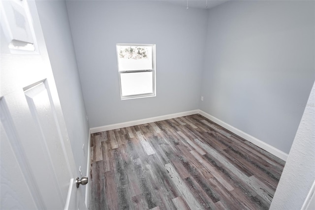 spare room featuring wood-type flooring