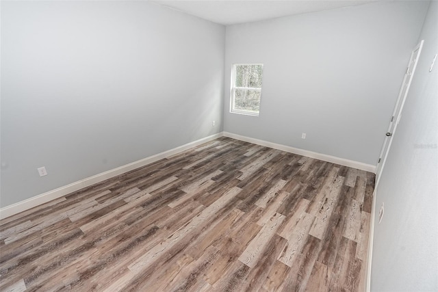 spare room with wood-type flooring