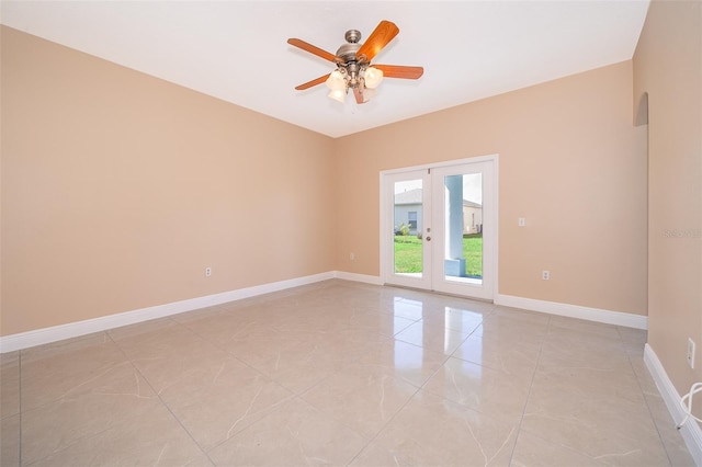 spare room featuring ceiling fan and french doors