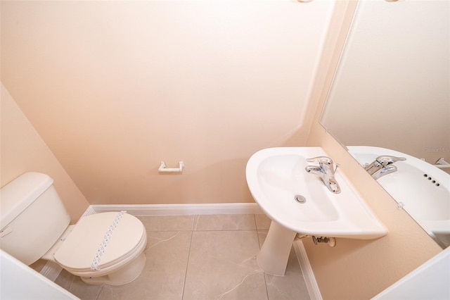 bathroom featuring tile patterned flooring, toilet, and sink