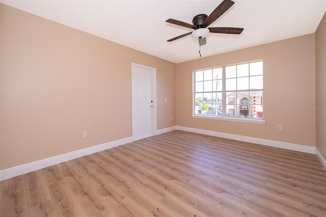 empty room with ceiling fan and light hardwood / wood-style floors